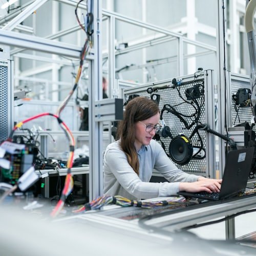 Engineer testing wiring on a production line