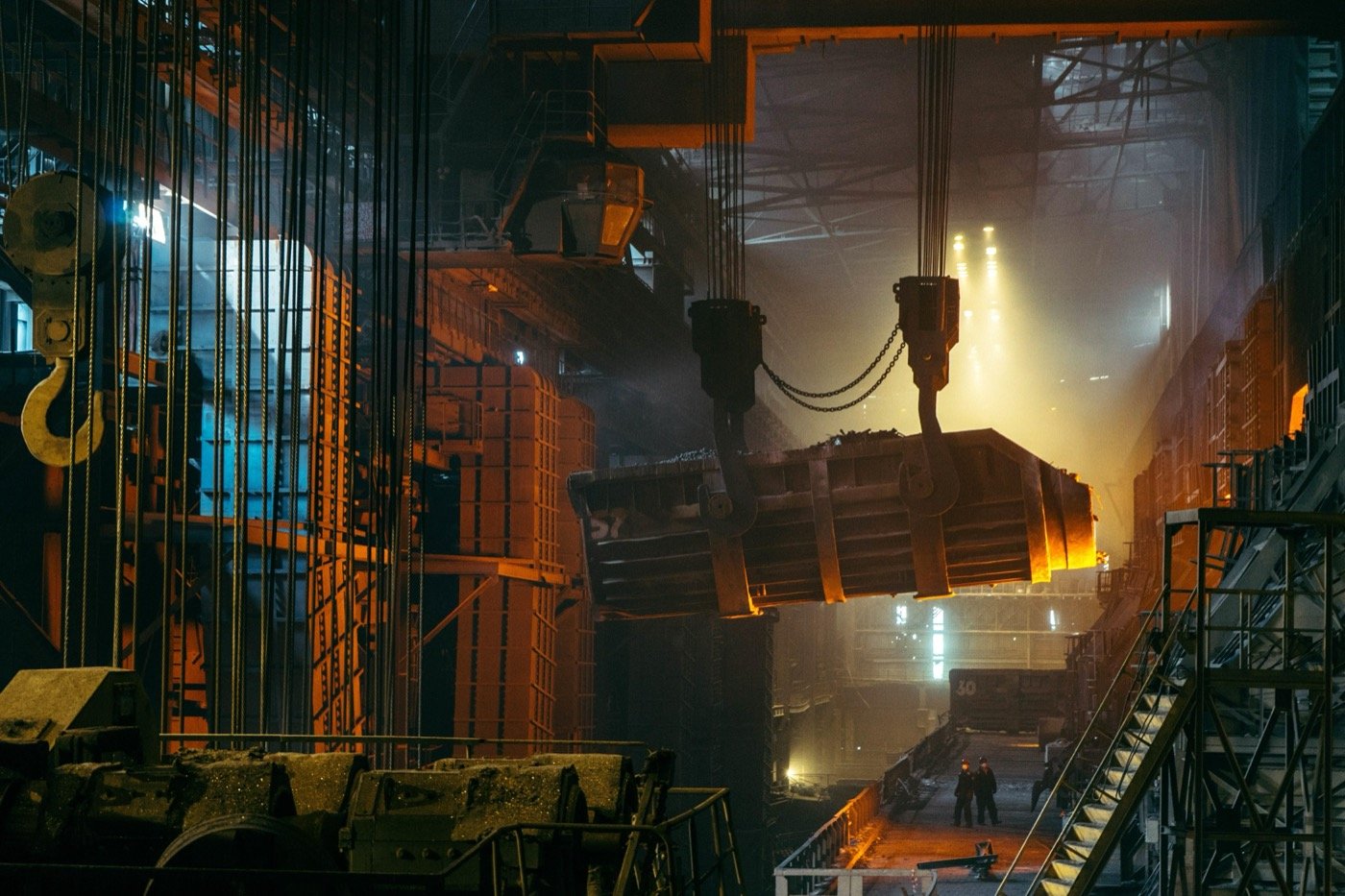 Steel mill overhead crane moving a ladle of molten metal